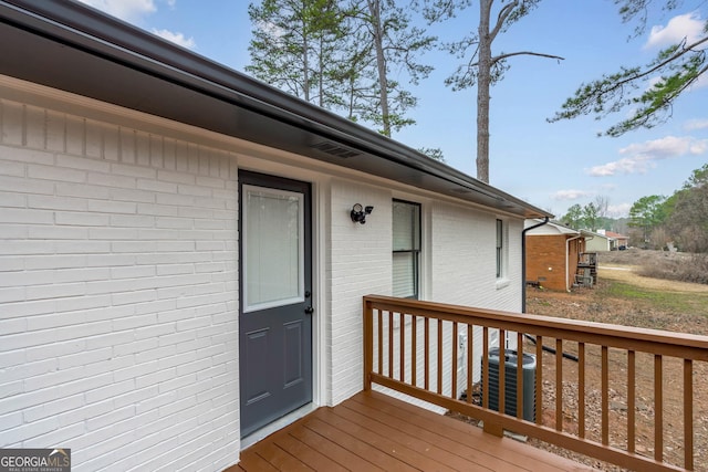 wooden deck with central AC unit