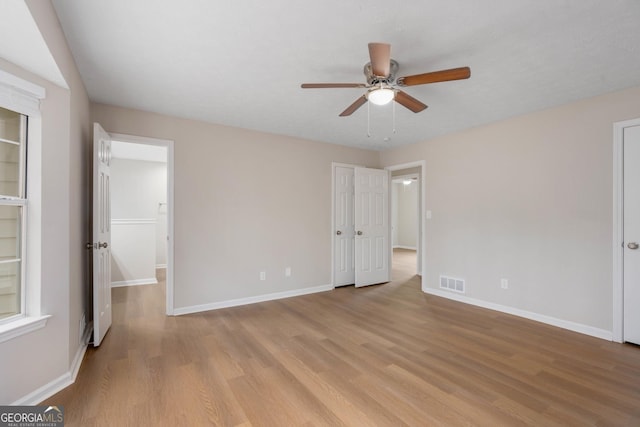 unfurnished bedroom with ceiling fan and light hardwood / wood-style flooring