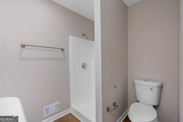 bathroom with a shower and toilet