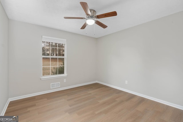 empty room with ceiling fan and light wood-type flooring