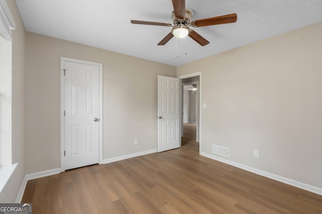 unfurnished bedroom with ceiling fan and light hardwood / wood-style flooring