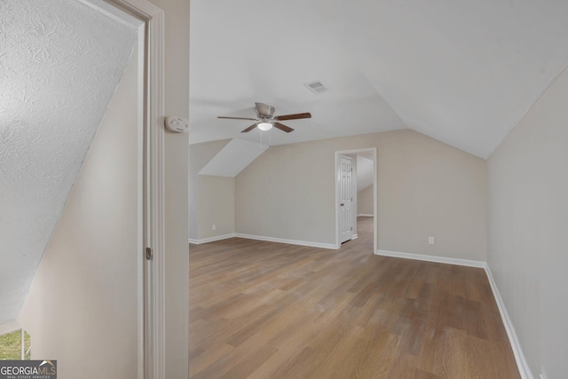 bonus room featuring ceiling fan, lofted ceiling, and light hardwood / wood-style floors