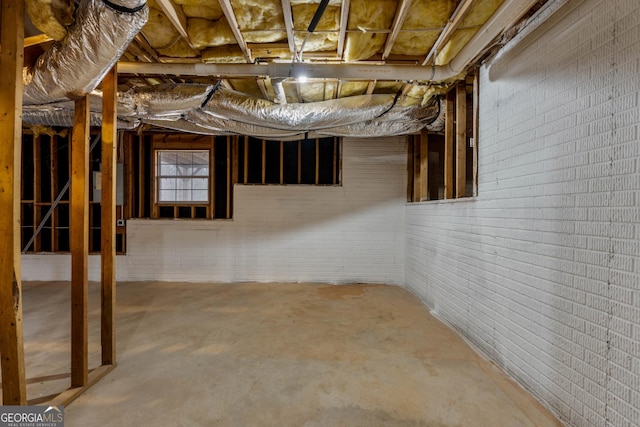 basement with brick wall