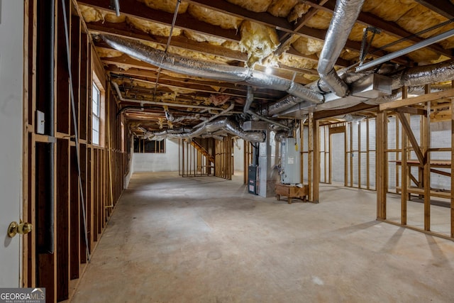 basement featuring water heater and heating unit