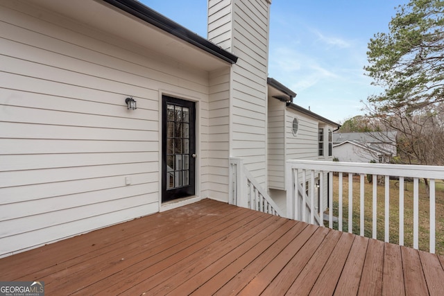 wooden terrace with a yard