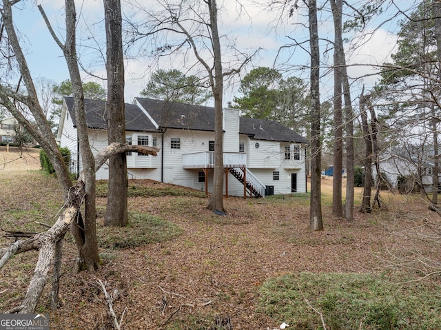 back of house featuring a deck