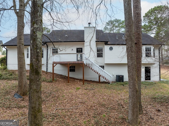 back of house featuring central AC unit and a deck