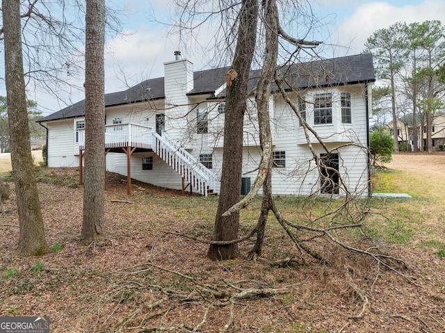 back of property with a wooden deck