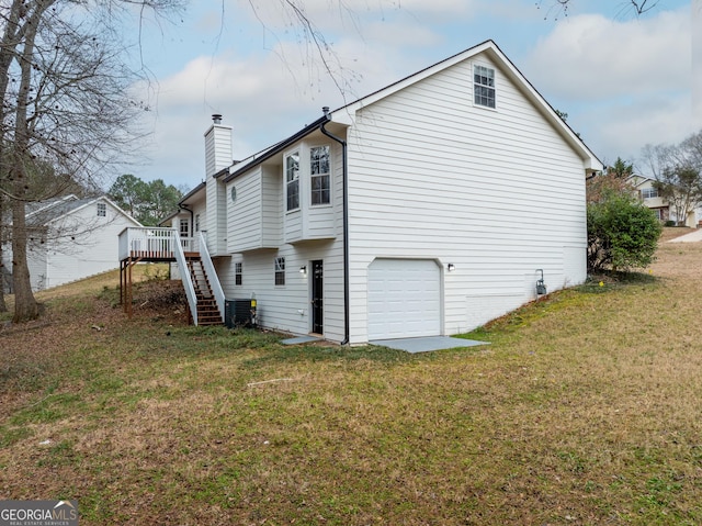 view of property exterior featuring cooling unit, a wooden deck, a garage, and a yard