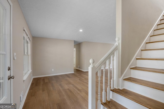 stairs featuring wood-type flooring