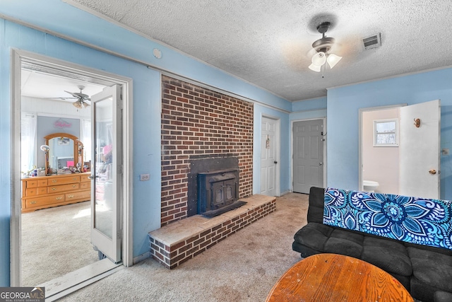 carpeted living room with a textured ceiling and ceiling fan