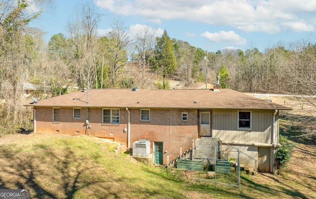 back of house featuring a yard and central AC unit