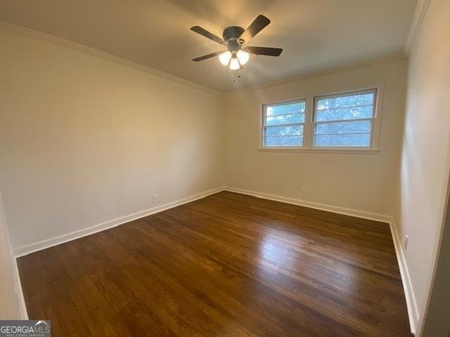 empty room featuring ceiling fan, ornamental molding, and dark hardwood / wood-style flooring