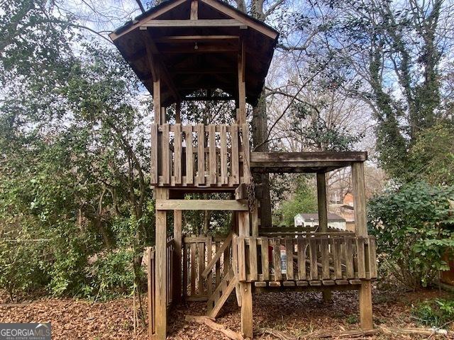 wooden terrace with a playground