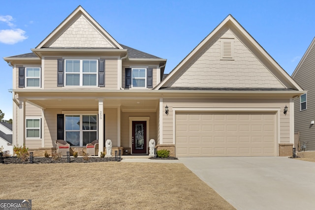 craftsman-style home with a porch, driveway, and an attached garage