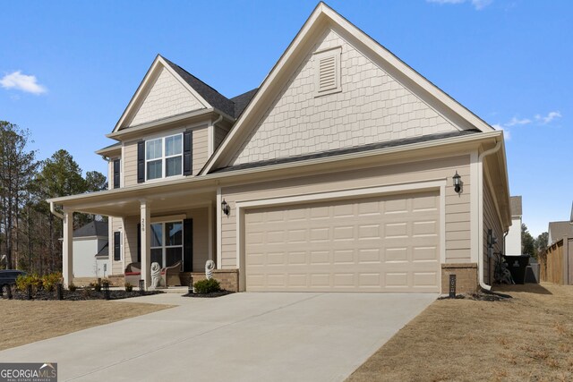 view of front of property with a porch and a garage