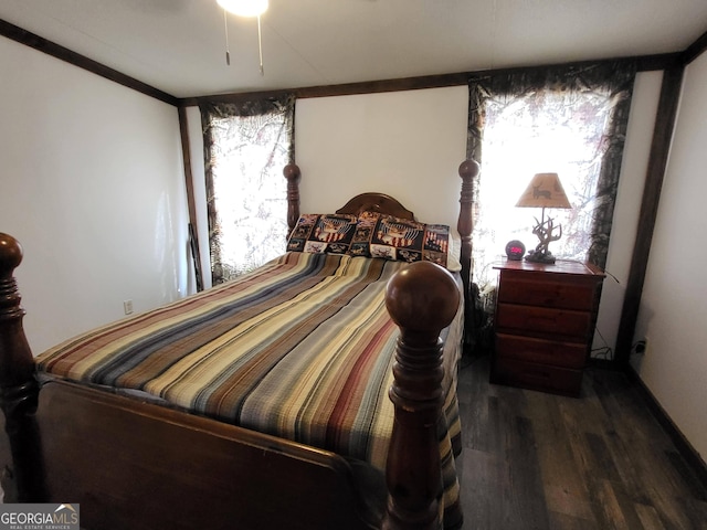 bedroom featuring ornamental molding and dark hardwood / wood-style floors