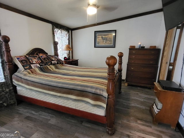 bedroom with vaulted ceiling and dark hardwood / wood-style flooring