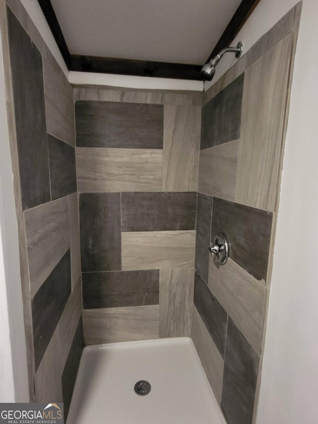 bathroom with a tile shower