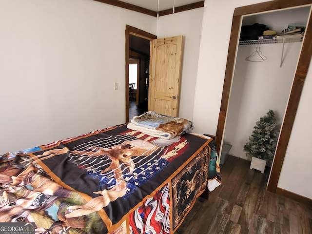 bedroom with dark wood-type flooring and a closet