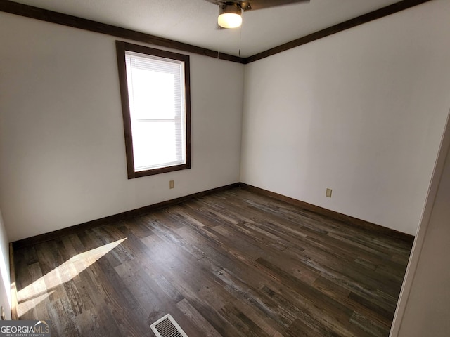 spare room with ceiling fan and dark hardwood / wood-style flooring