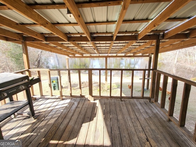 wooden deck with a water view and grilling area