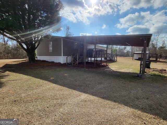 exterior space featuring a wooden deck and a lawn