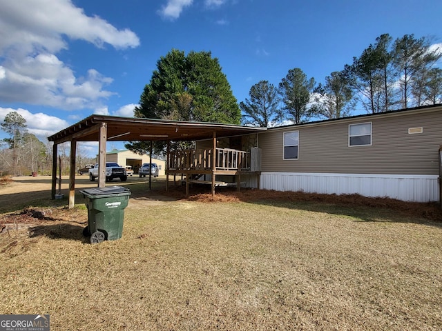 view of front of house with a deck and a front yard