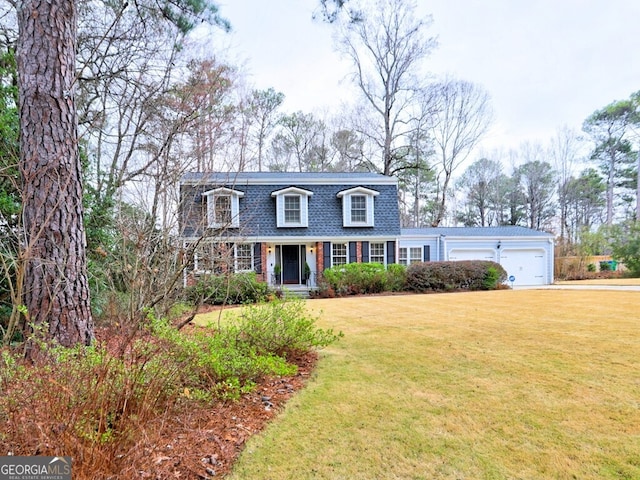 new england style home featuring a garage and a front yard