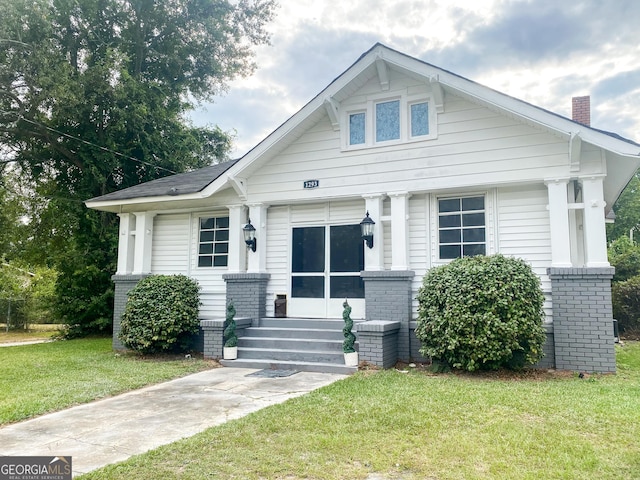 bungalow-style home featuring a front yard