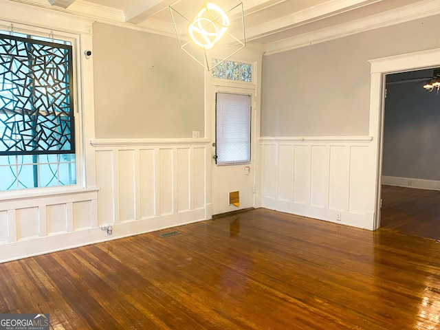 unfurnished room featuring beam ceiling, a notable chandelier, crown molding, and dark hardwood / wood-style floors