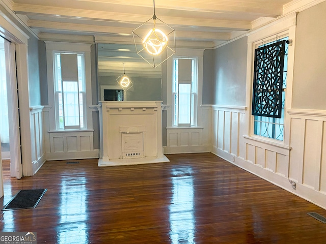 unfurnished dining area featuring dark hardwood / wood-style flooring, crown molding, and beam ceiling