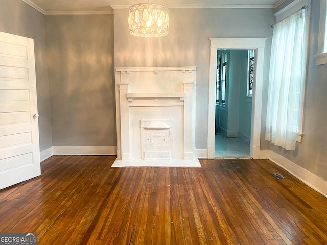 unfurnished living room featuring ornamental molding, an inviting chandelier, and dark hardwood / wood-style flooring