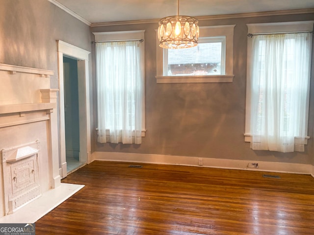 unfurnished dining area with ornamental molding, dark hardwood / wood-style floors, and a chandelier