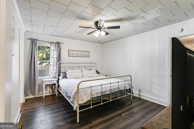 bedroom featuring ceiling fan and dark hardwood / wood-style floors