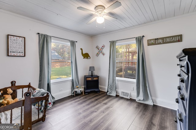 interior space with ornamental molding, a healthy amount of sunlight, and dark hardwood / wood-style floors