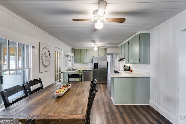 dining area featuring crown molding, dark hardwood / wood-style floors, and sink