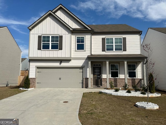 craftsman-style home featuring a garage, a porch, and a front yard