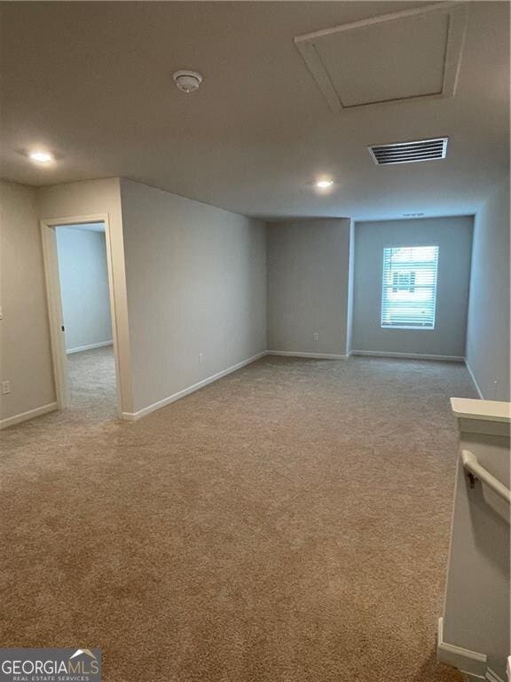 basement featuring light colored carpet