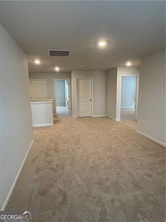 unfurnished room featuring light colored carpet