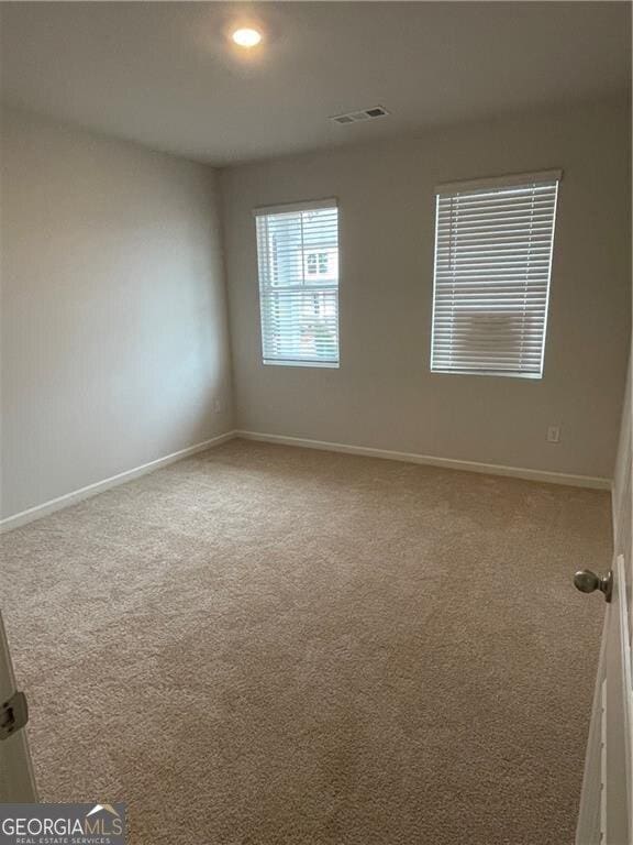 unfurnished room with carpet flooring