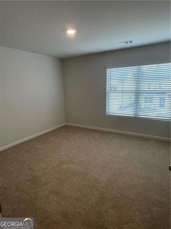 unfurnished room with carpet flooring