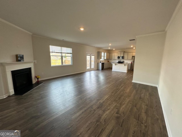 unfurnished living room featuring ornamental molding and dark hardwood / wood-style flooring