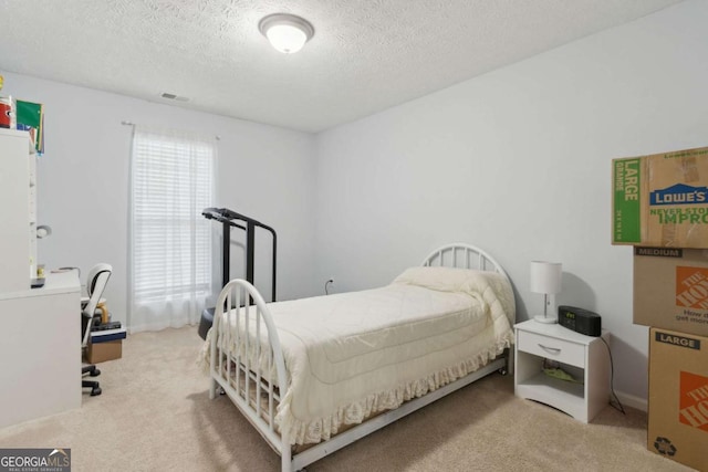 carpeted bedroom with a textured ceiling