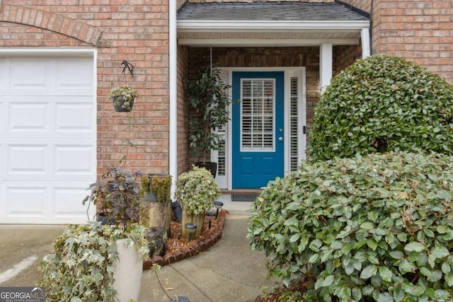 view of exterior entry featuring a garage