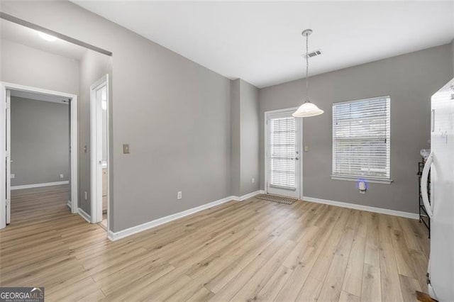 unfurnished dining area featuring light hardwood / wood-style floors