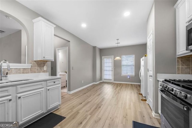 kitchen with white cabinetry, sink, decorative backsplash, and appliances with stainless steel finishes