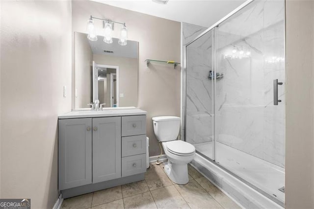 bathroom with vanity, toilet, tile patterned floors, and walk in shower