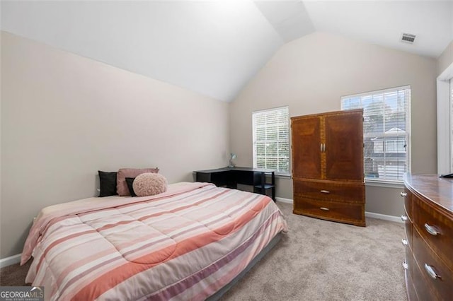 carpeted bedroom with vaulted ceiling