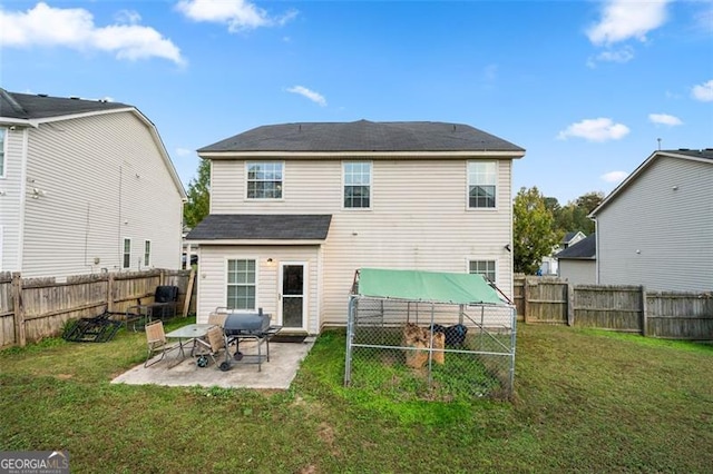 rear view of house with a yard and a patio